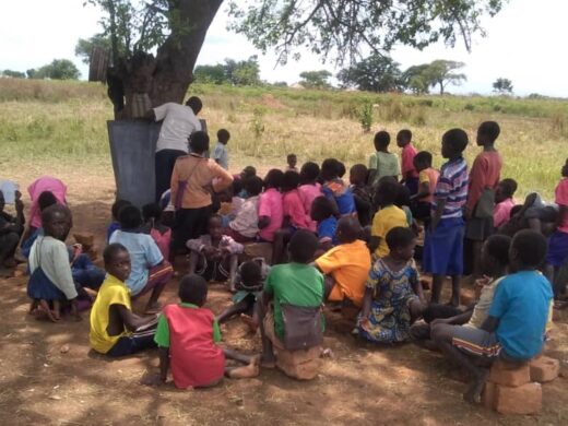 Lomokori pupils studying under tree Photo courtesy of Signpost International